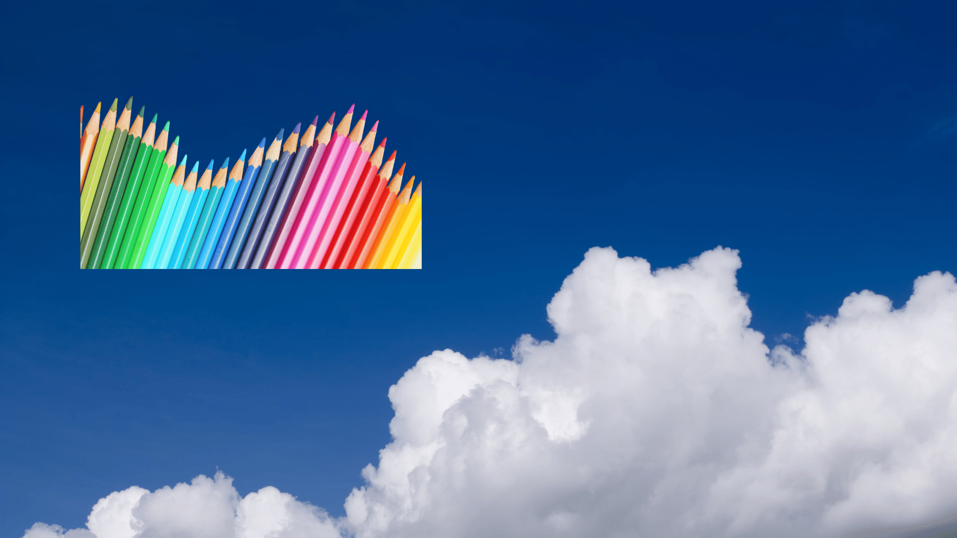 Weisse Wolken am blauen Himmel, und bunte regenbogenfarbenen Buntstifte